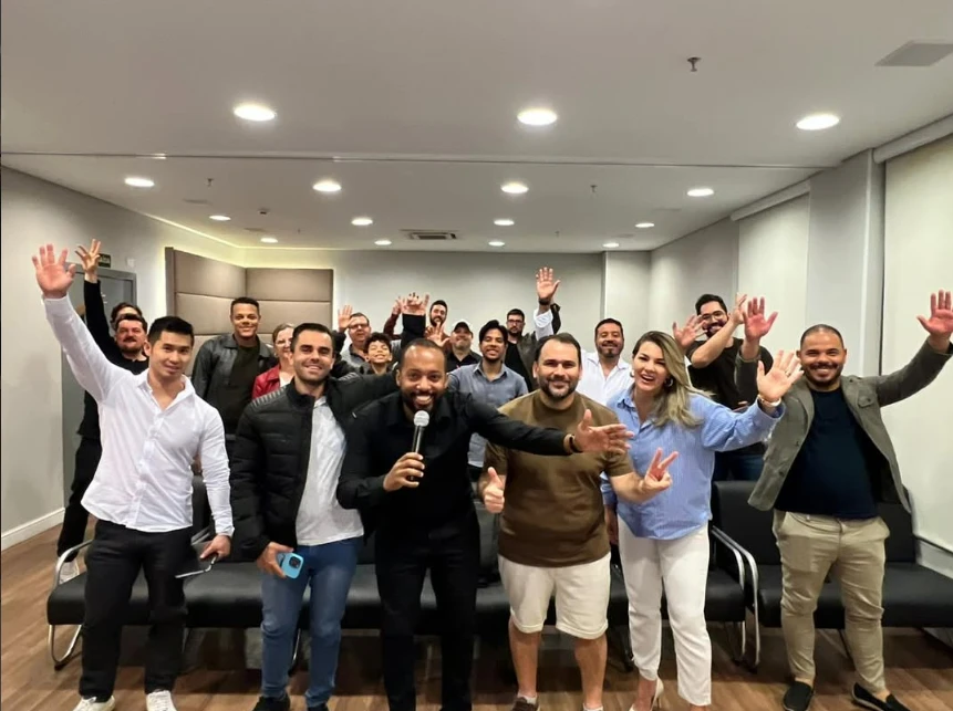 Mateus com microfone ao lado dos participantes